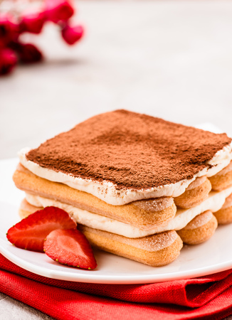 Tiramisu with strawberry on the table. Valentines concept.の写真素材
