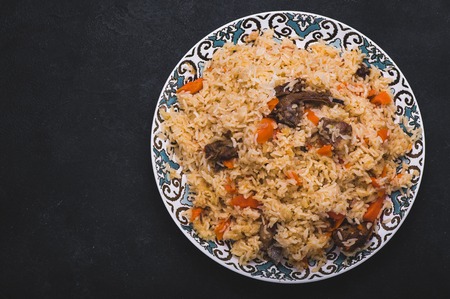 Pilaf on plate with oriental ornament. Central-Asian cuisine - Plov. Top view.の写真素材