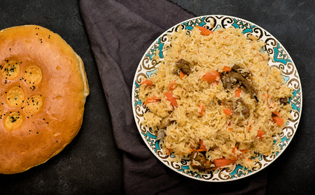Pilaf on plate with oriental ornament and Traditional Asian breads - churek. Central-Asian cuisine - plov. Top view.の写真素材
