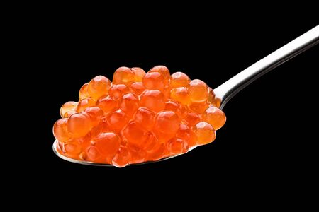 red caviar in the silver spoon isolated on a black background with clipping path close up macroの写真素材