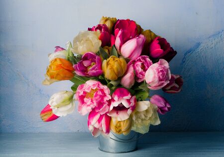 A bouquet of flowers on a blue background. Tulips. Vintage style.の写真素材