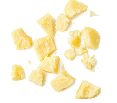 Parmesan cheese pieces on white background. Italian cheese slices. Top view.の写真素材