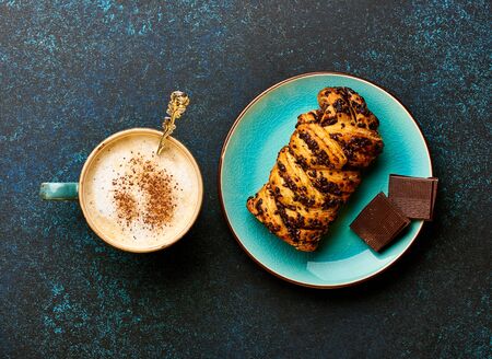 Breakfast with coffee, chocolate and bakery product on blue background. Coffee. Top view.の写真素材