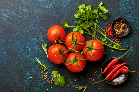 Tomatoes, parsley and pepper on blue concrete backgroundの写真素材