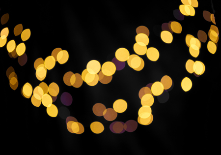 Orange circles bokeh on black background.の写真素材