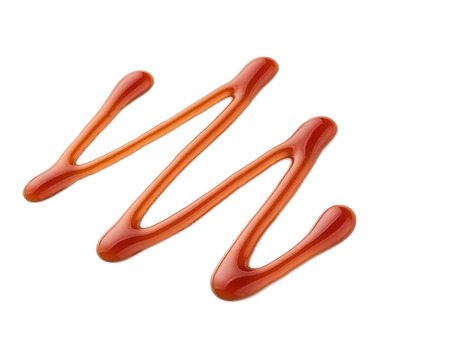 Sweet caramel sauce isolated on white background, top view.の写真素材