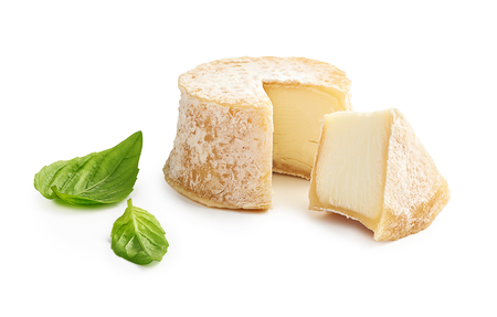 Crottin cheese sliced isolated on white backgroundの写真素材