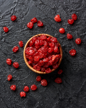 Dried red cherries on a black background with copy space.の写真素材
