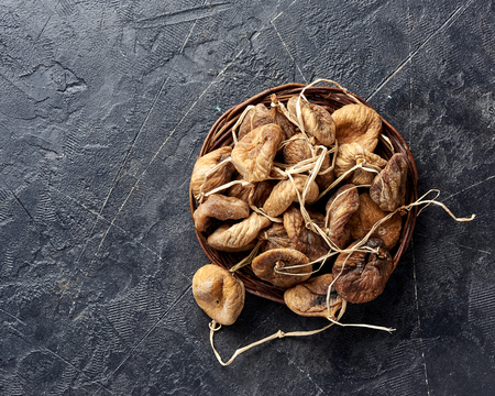 Heap of dried figs on black background with copy space.の写真素材