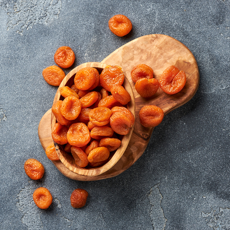 Dried apricots on gray background. Top view.の写真素材