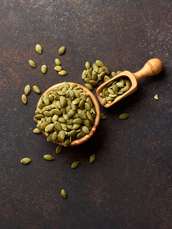 Pumpkin seeds on brown background.の写真素材