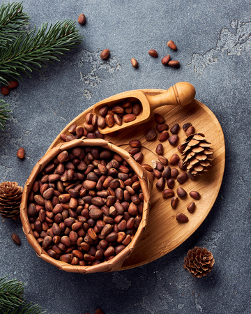 Pine nuts in bowl on gray stone table. Top view.の写真素材
