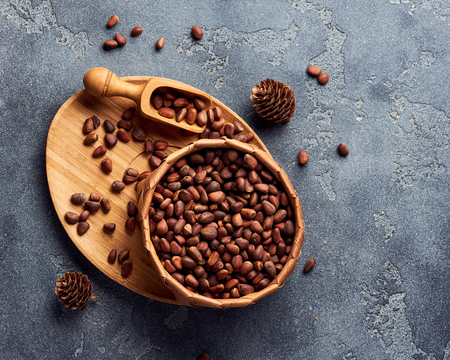 Pine nuts in bowl on gray stone table. Top view with copy spaceの写真素材