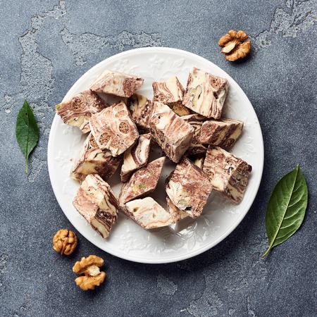 Oriental sweet dessert. Eastern halva on a white plate. Top view.の写真素材