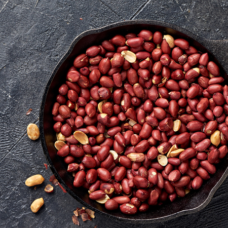 Fried peanut in pan on black background. Top view.の写真素材