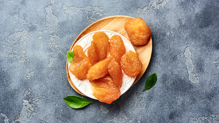 Candied sliced pear. Dried fruits on gray background. Top view.の写真素材