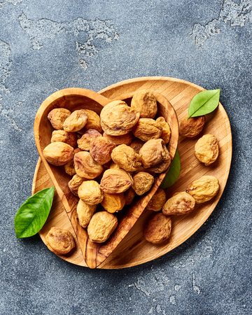 Sun dried apricots on gray concrete background. Top view.の写真素材