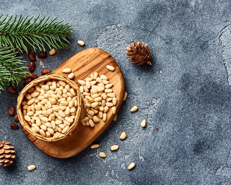 Peeled pine nuts with copy space on gray background. Top view.の写真素材