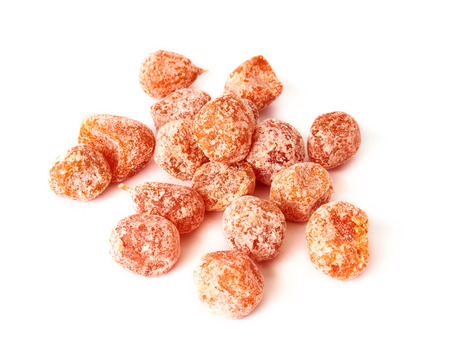 Dried sweet kumquat under powdered sugar isolated on white background.の写真素材