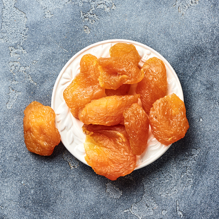 Candied sliced pear. Dried fruits on gray background. Top view.の写真素材