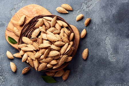 Almonds on gray concrete background. Top view.の写真素材