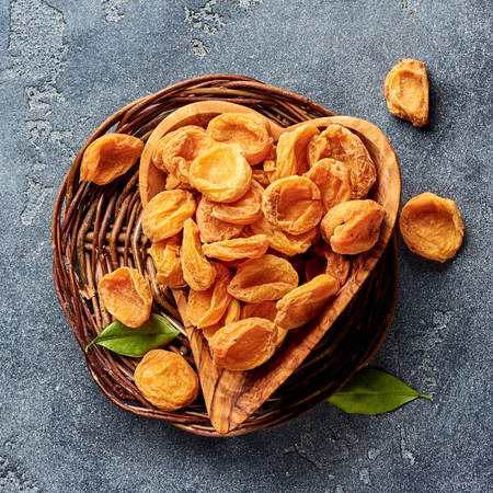 Dried apricots on gray concrete background. Top view.の写真素材