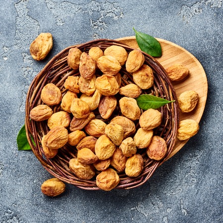 Sun dried apricots on gray concrete background. Top view.の写真素材