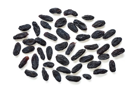 Black raisins isolated on white background. Top view of dried grapes.の写真素材