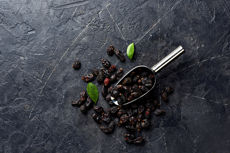 Dried rosehip in scoop on black background with copy space.の写真素材