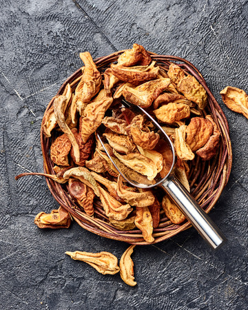 Dried pear, apple on black table. Top view.の写真素材