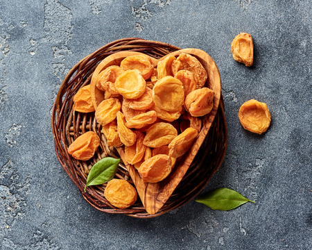 Dried apricots on gray concrete background. Top view.の写真素材
