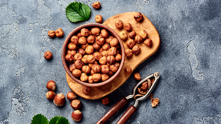 Hazelnuts with nutcracker on gray background. Top view of nuts.の写真素材
