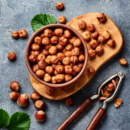 Hazelnuts with nutcracker on gray background. Top view of nuts.の写真素材
