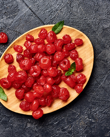 Candied dried cherry on plate. Top view of berries.の写真素材