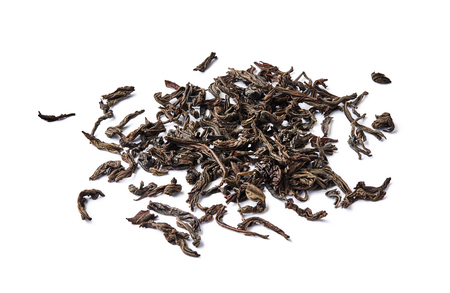 Heap of dried black tea leaves isolated on white background.の写真素材