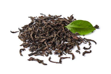 Heap of dried black tea leaves isolated on white background.の写真素材