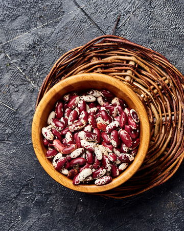Red beans with white spots on black background. Top view.の写真素材