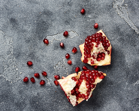 Pomegranate fruit with seeds on gray background with copy space. Top view.の写真素材