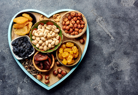 Mix dried fruits and nuts on gray background. Top view of superfoods.の写真素材