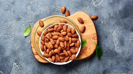 Almond nuts on gray background. Top view of roasted snacks.の写真素材