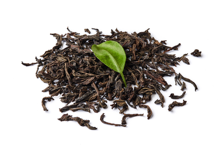 Heap of dried black tea leaves isolated on white background.の写真素材