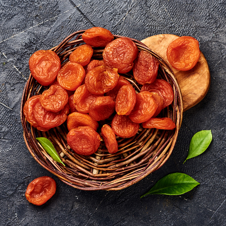Dried apricots on gray background. Top view.の写真素材