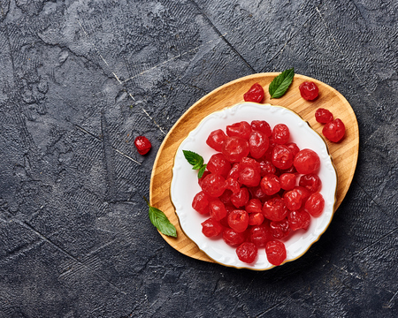 Candied dried cherry on plate. Top view of berries.の写真素材