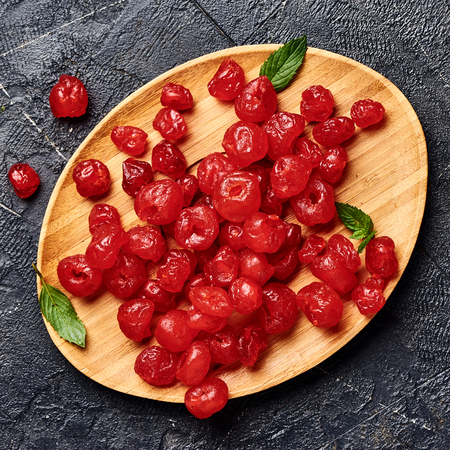 Candied dried cherry on plate. Top view of berries.の写真素材