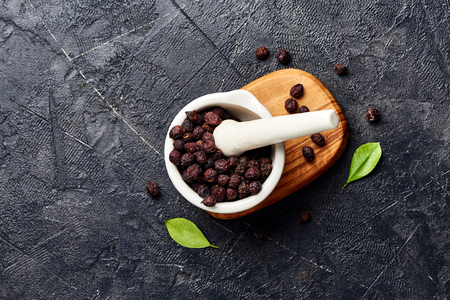 Dried hawthorn fruits on black background. Top view of Crataegi fructus.の写真素材