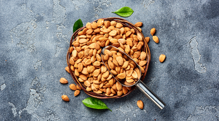 Almond nuts on gray background with copy space. Top view of snacks.の写真素材