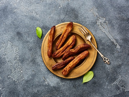 Dried bananas on gray background with copy space. Top view.の写真素材