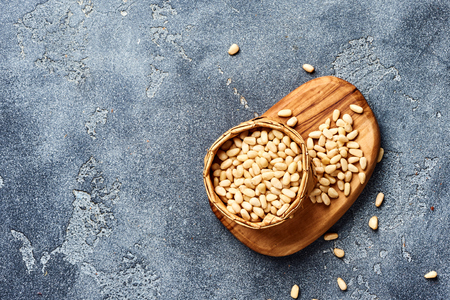 Peeled pine nuts with copy space on gray background. Top view.の写真素材