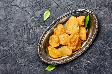 Dried pear, apricot or peach on black background. Top view of candied fruits.の写真素材
