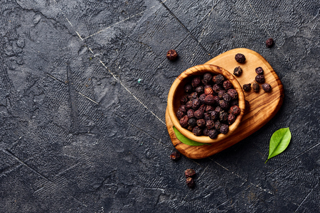 Dried hawthorn fruits on black background. Top view of Crataegi fructus.の写真素材